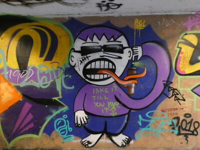 Man with sunglasses and purple hair in purple shirt