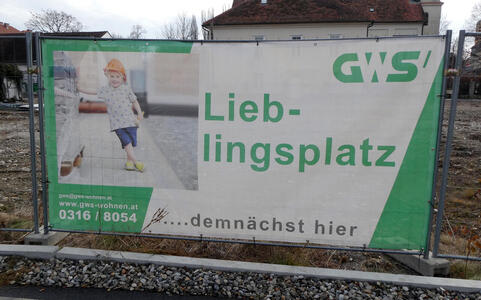 Sign at construction area with little girl in hard hat. Lieblingsplatz...demnächts hier