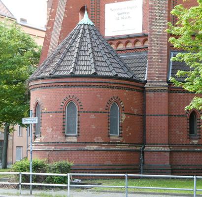 cylindrical section of church buliding with a conical roof.