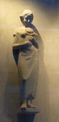 sculpture of woman holding flowers