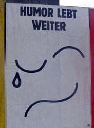Humor lives on Half-smiling, half-crying line drawing of eyes and mouth with text “Humor lives on”.