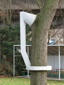 white cement ring around tree attached to branch