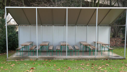benches and tables under slanted roof