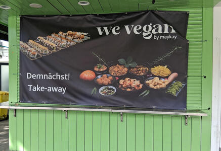 Poster for we vegan by maykay showing vegan food. Text: Demnäachst! Take-away