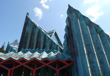 Angular projections on roof of side buliding of the church.