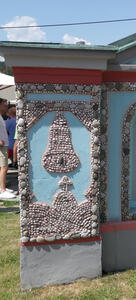 Upper half is a bell. Lower half shows a hill with a cross atop it.