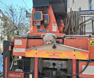 Construction equipment with teddy bear resting in the framework