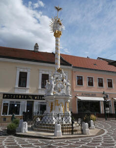 White column with gold trim, srrounded by holy figures