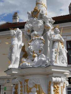 Detail of bottom of column, showing one figure pierced by arrows, and another holding a staff. Both have gold halos.