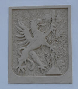 Heraldic shield with gryphon holding a grape vine