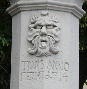Demonic face with tongue sticking out. Date appears to be 1714.