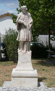 statue of man in clerical garb. he has a beard.