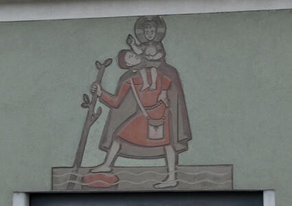 Drawing on wall of an apothecary. Depicts a man with a staff. On his shoulder, baby Jesus with a halo framing his head.