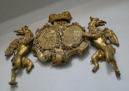 Gold coat of arms held by two griffins/eagles?