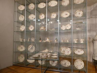 A display case 7 columns by 6 rows high, each section with ceramic dishware.