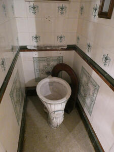 small room with ceramic toilet