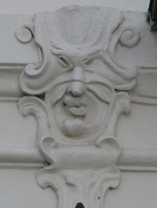 Man with mask and lips pursed, slightly twisted