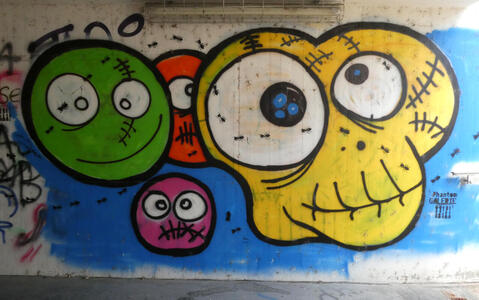 Green, red, and yellow faces with comical expressions.