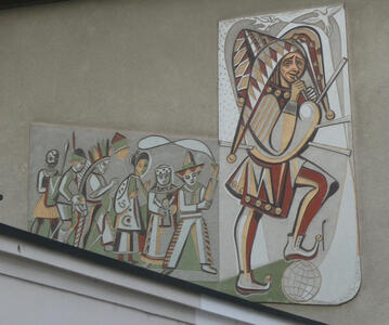 Wall painting of man in jester’s hat playing bagpipes. He is followed by a procession of children in costumes.