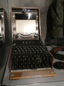 World War II era Enigma coding machine with kezboard, and, below it, a plugboard of the letters