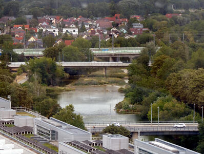 View of river with three bridges horizontally across the photo.