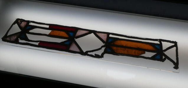 Broken and partially melted stained glass window.
