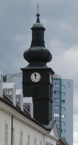 Top of church tower with a somewhat onion-shaped steeple