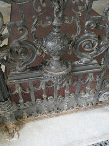 Detail of wrought iron gate. Several uprights at bottom, with curlicue forms above