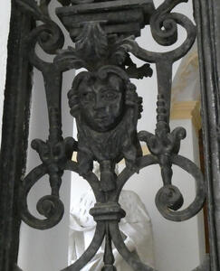 Deteail of gate; human head in center with two down-pointing spears on either side