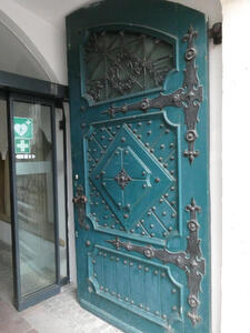 Metalwork on turquoise-colored door