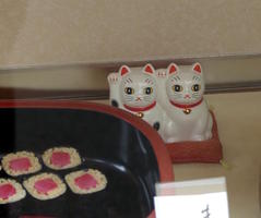 cat figurines in restaurant display case cat figurines in restaurant display case
