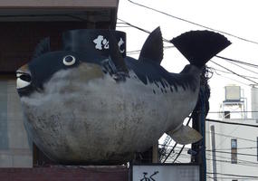 fat fish statue above restaurant fat fish statue above restaurant