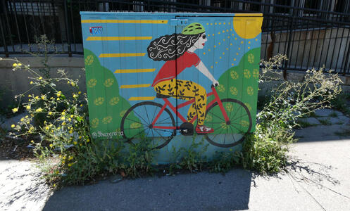 utility box woman on bicycle