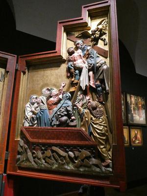 Painted wooden altarpiece depicting Jesus being taken down from the cross
