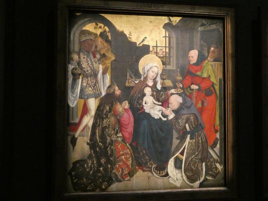 Adoration of the magi. One of them is kissing baby Jesus’s foot.