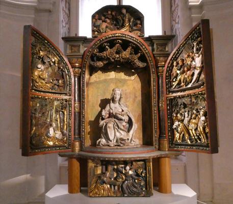 Altarpiece with Mary in center, reading from a book.