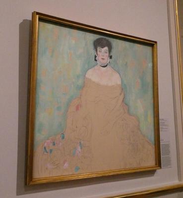 Painting of woman in a low-cut flowing yellow dress.