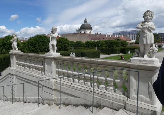 Ledge behind a staircase. On the ledge are three statues with themes for the months, and the statues are labeled with the month name.