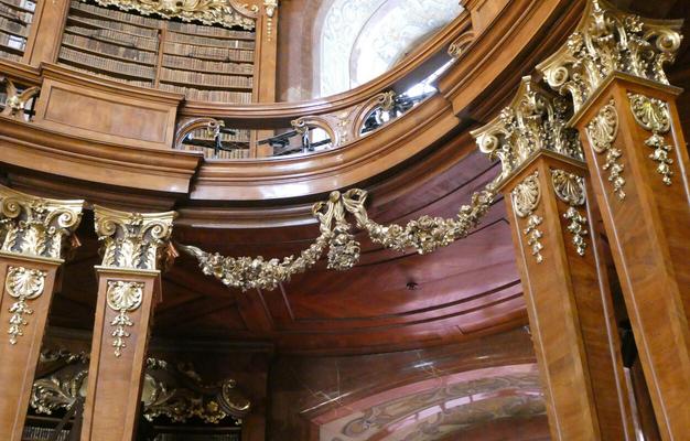 Gold trim on dark brown wooden columns