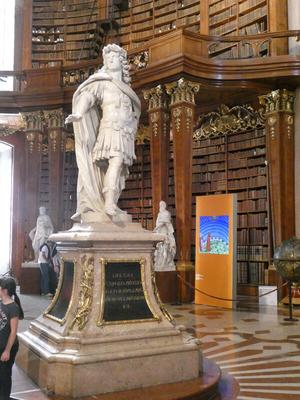 Marble statue of man wearing Roman-style garb and a long flowing cape