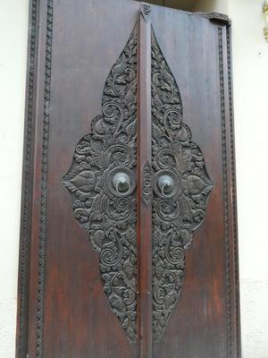 Ornate metal work on wood doors