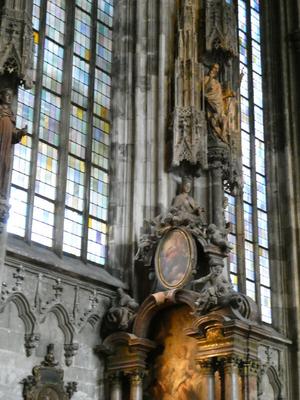 Statuary and painting in center, at left, stained glass windows in pastel colors