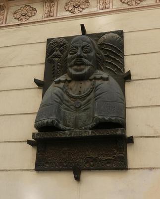 Metal sculpture of smiling man with moustache