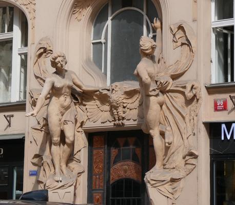 Two standing women on either side of a window