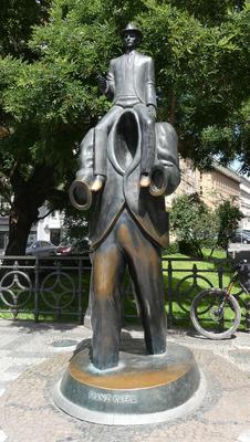 Bronze sculpture in honor of Franz Kafka. Depicts a man sitting on shoulders of a headless, handless person.