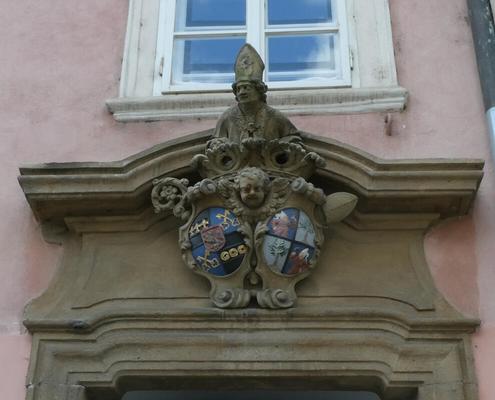 Sculpture above abbey door showing a man in bishop’s mitre.