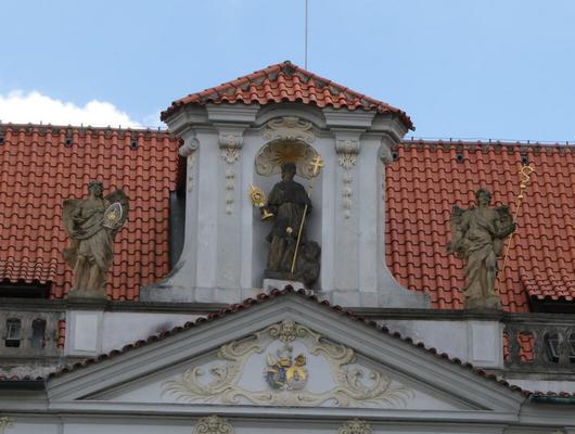 Niche above entrance door with a holy man holding a staff and icon both plated in gold