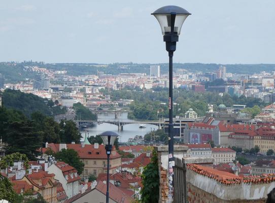 View of Prague from atop a hill. Three bridges are in the background.