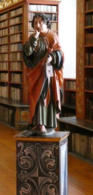 Statue of man with sad expression. He is holding his hand up to his cheek.