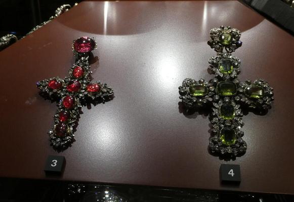 Two crosses, one adorned with red jewels, the other with green.
